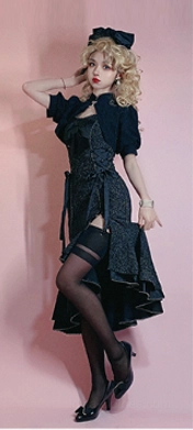Black fishtail Lolita JSK dress with dramatic silhouette, ruffled hemline and adjustable side splits, full-body standing view showcasing the signature design elements