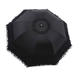 Black foldable sun parasol with octagonal canopy, full front view showcasing ruffled lace trim around edge and central top rosette decoration, pure product display