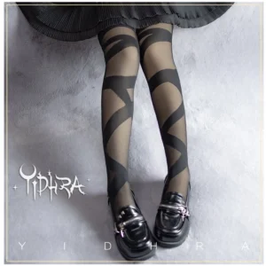 Black glass yarn lolita thigh stockings with white crisscross strap pattern paired with black pleated lolita skirt and black leather loafers overhead view