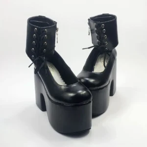 Black glossy lolita platform ankle boots with metal lace eyelets and thick block heel, three-quarter front view showcasing round toe and decorative lacing details