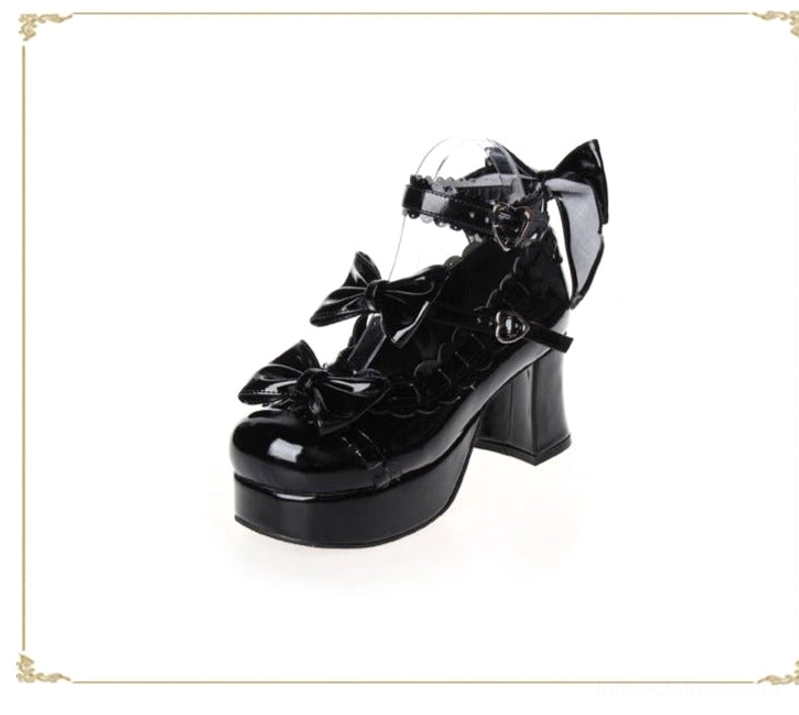Black glossy lolita platform heels side three-quarter view patent leather bow accents chunky block heel platform ankle strap buckle