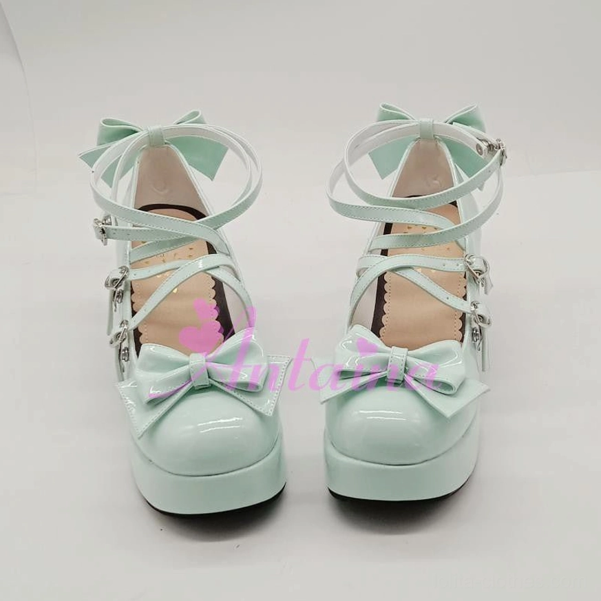 Black glossy sweet Lolita Mary Jane platform shoe front view highlighting bow toe cap ornament and crisscross strap configuration details