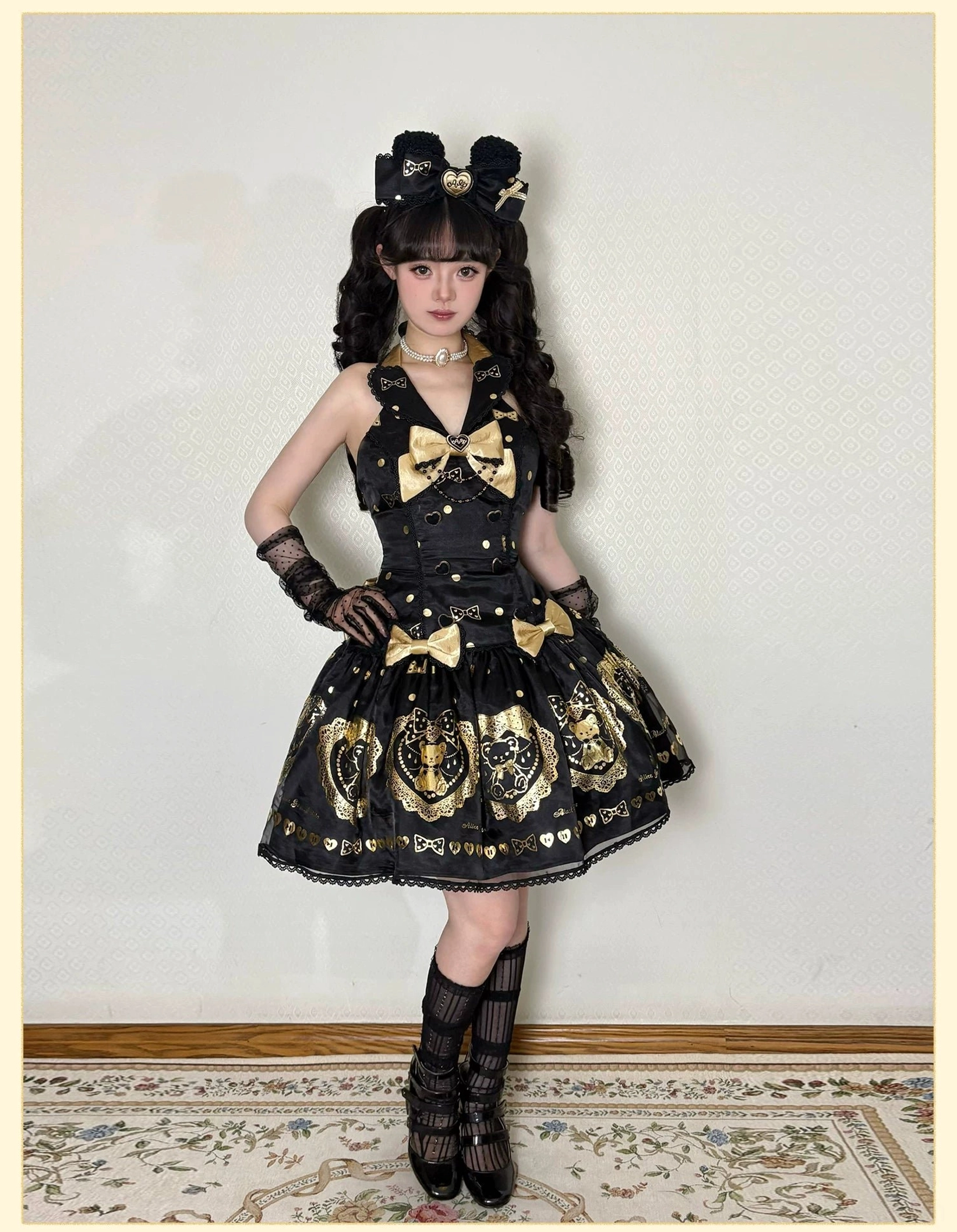 Alternative styling view of black and gold bear lolita dress worn or displayed with suggested lolita fashion coordinate elements, hair accessories, and fashion photography showcase