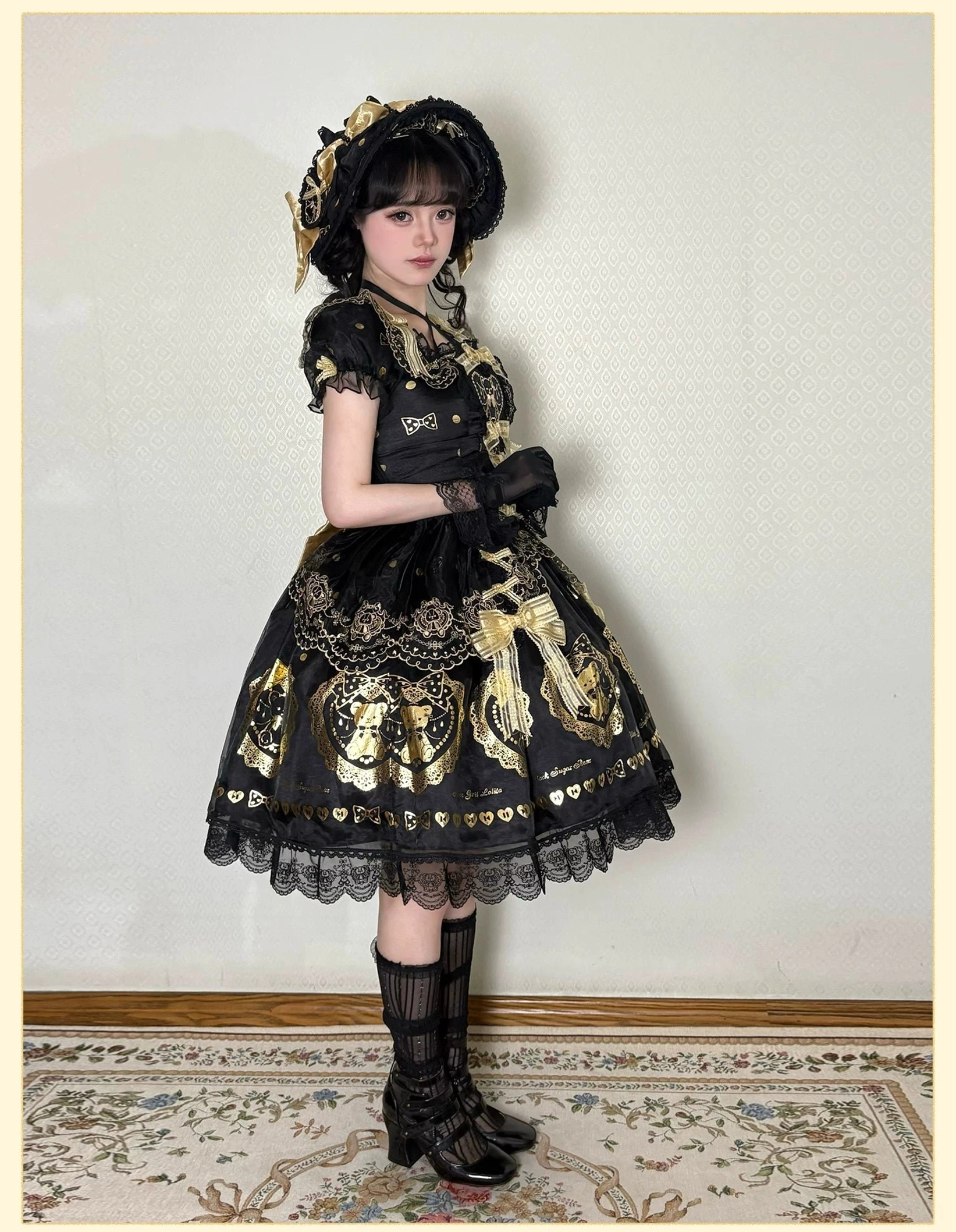 Detailed fabric macro photography revealing hot-stamped gold bear prints, tiny golden polka dots pattern, and polyester base fabric texture of black and gold bear lolita dress