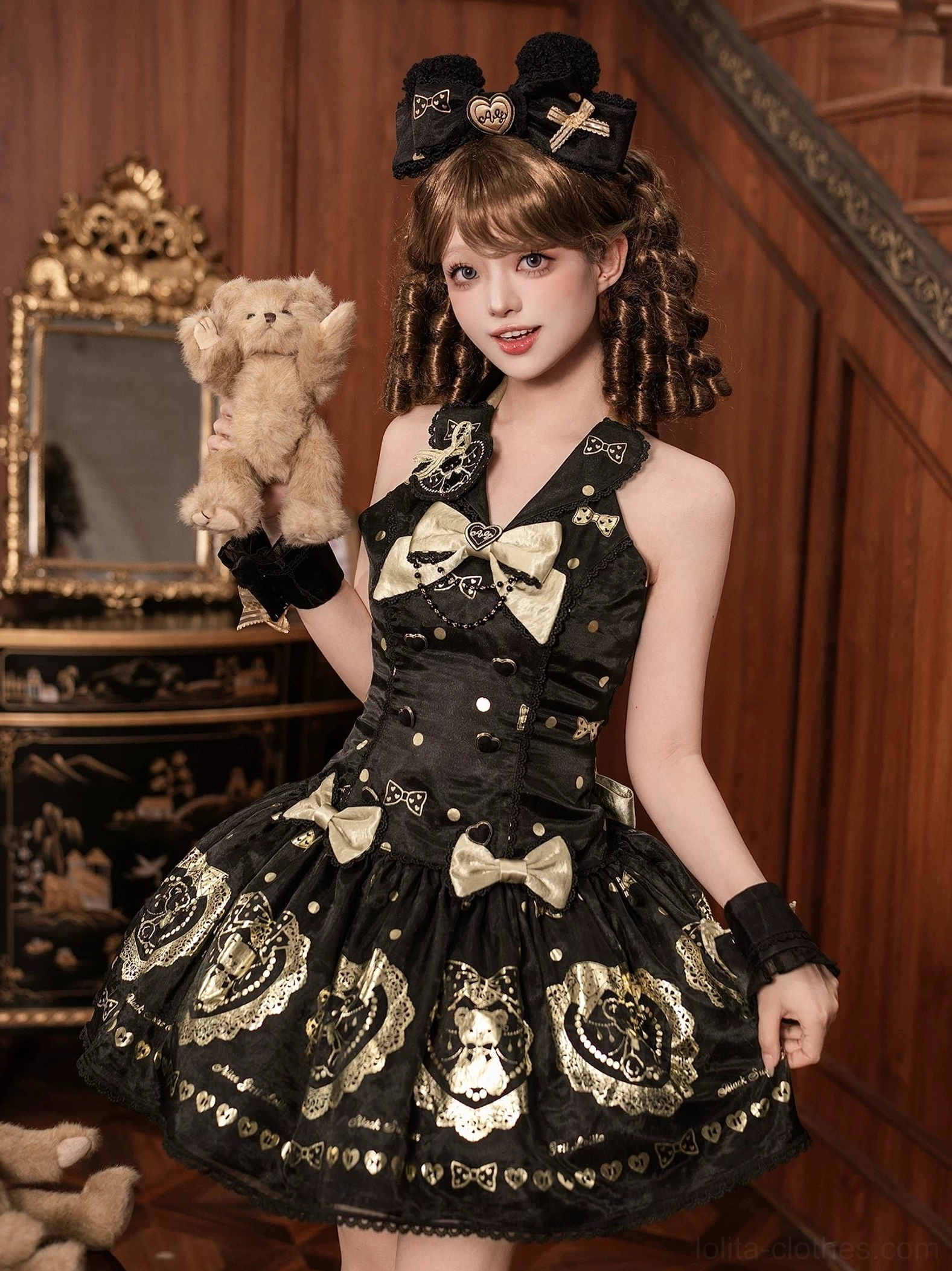 Close-up of lolita dress lace embellishments showing delicate lace borders, gold satin ribbon details, heart and bear motif prints on black polyester base fabric