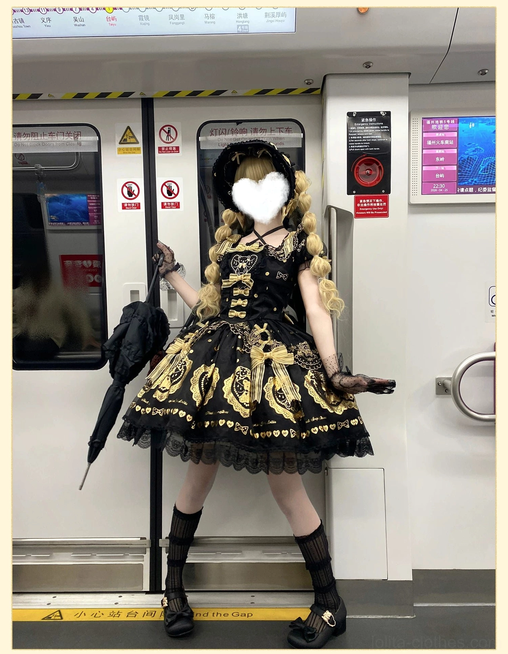 Overhead flat lay view of black and gold bear print lolita dress showing complete pattern distribution, hot-stamped teddy bear motifs, decorative heart elements, and overall design composition