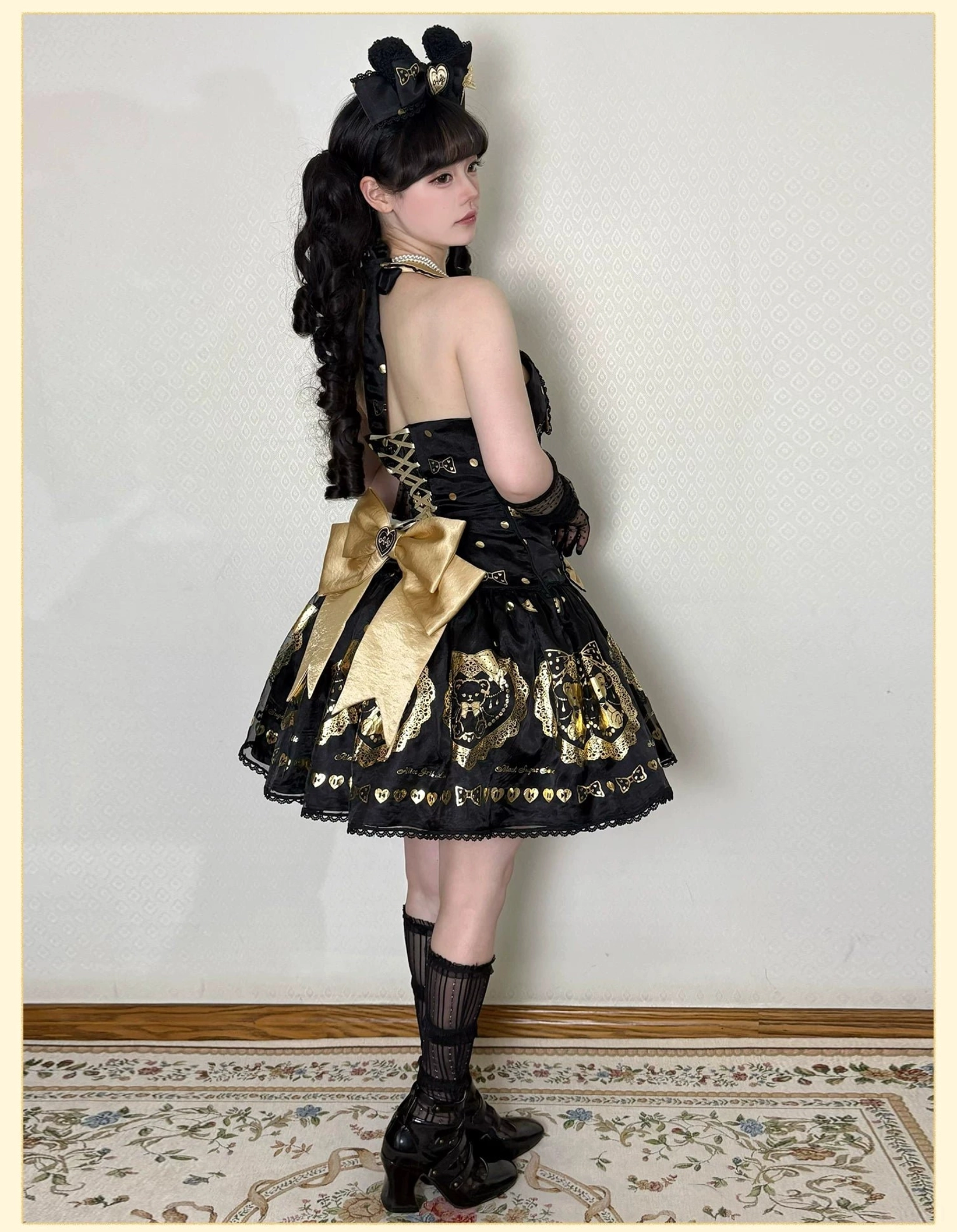 Quality assurance detail shot of black and gold bear lolita dress seams, stitching precision, lace application, and overall construction craftsmanship meeting high standards