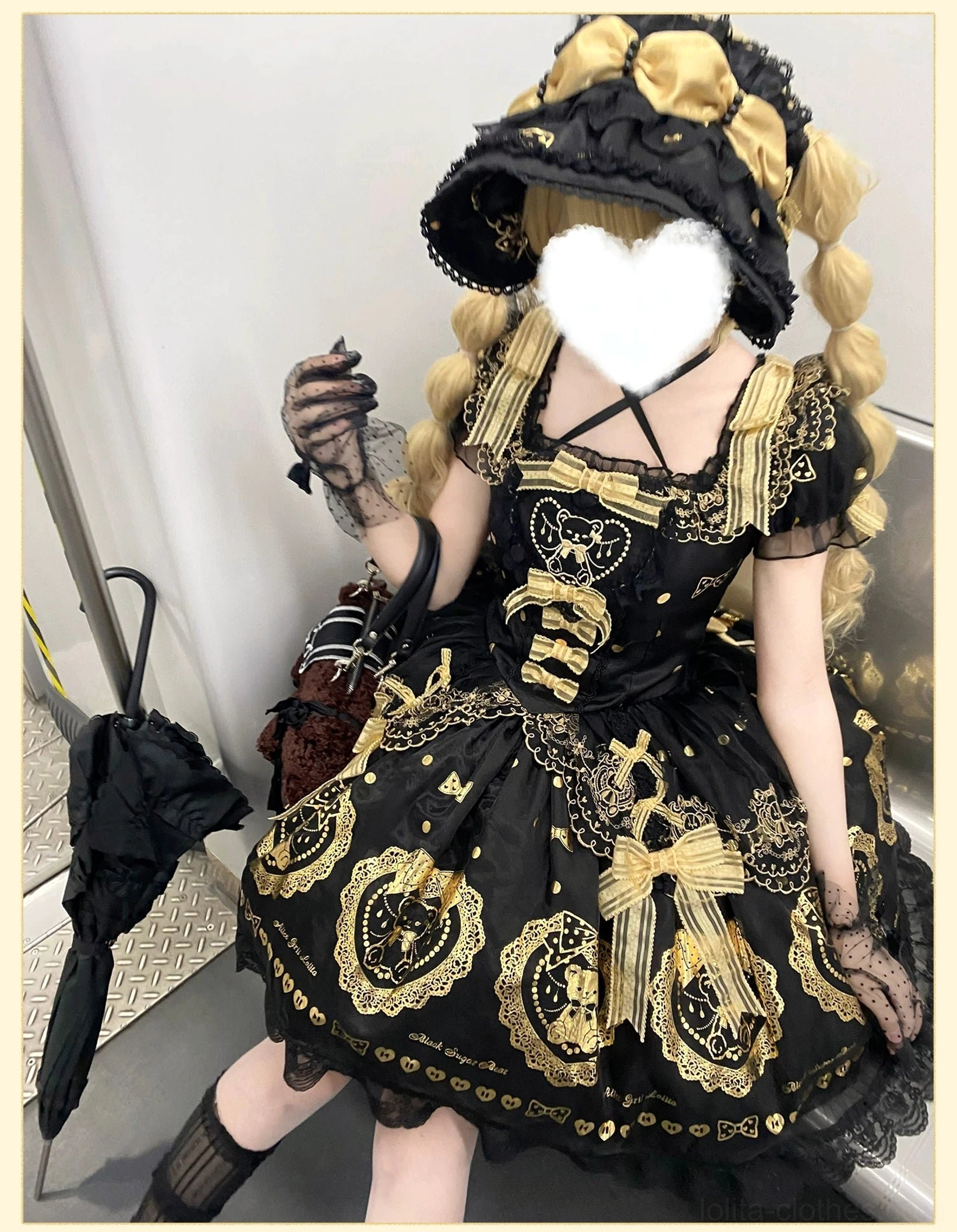 Layering and coordination inspiration shot showing black and gold bear lolita dress paired with recommended accessories, demonstrating how to style for different lolita occasions and themes