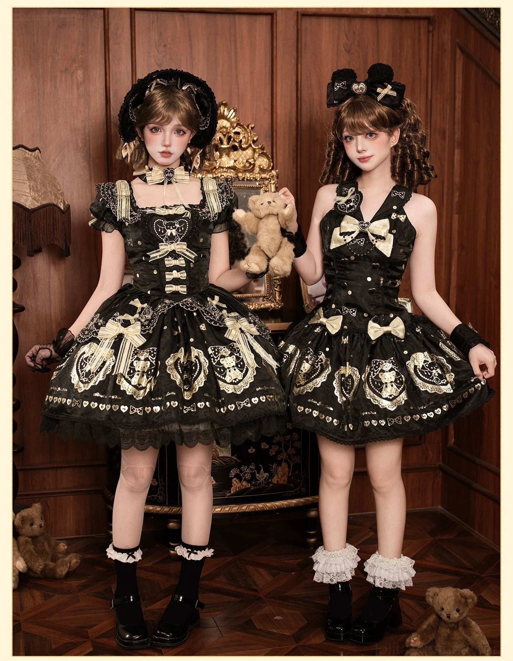 Twin black and gold bear print lolita one-piece dresses on models in vintage interior setting with teddy bear props, showcasing classic old school lolita aesthetic with ruffled hems and decorative bows