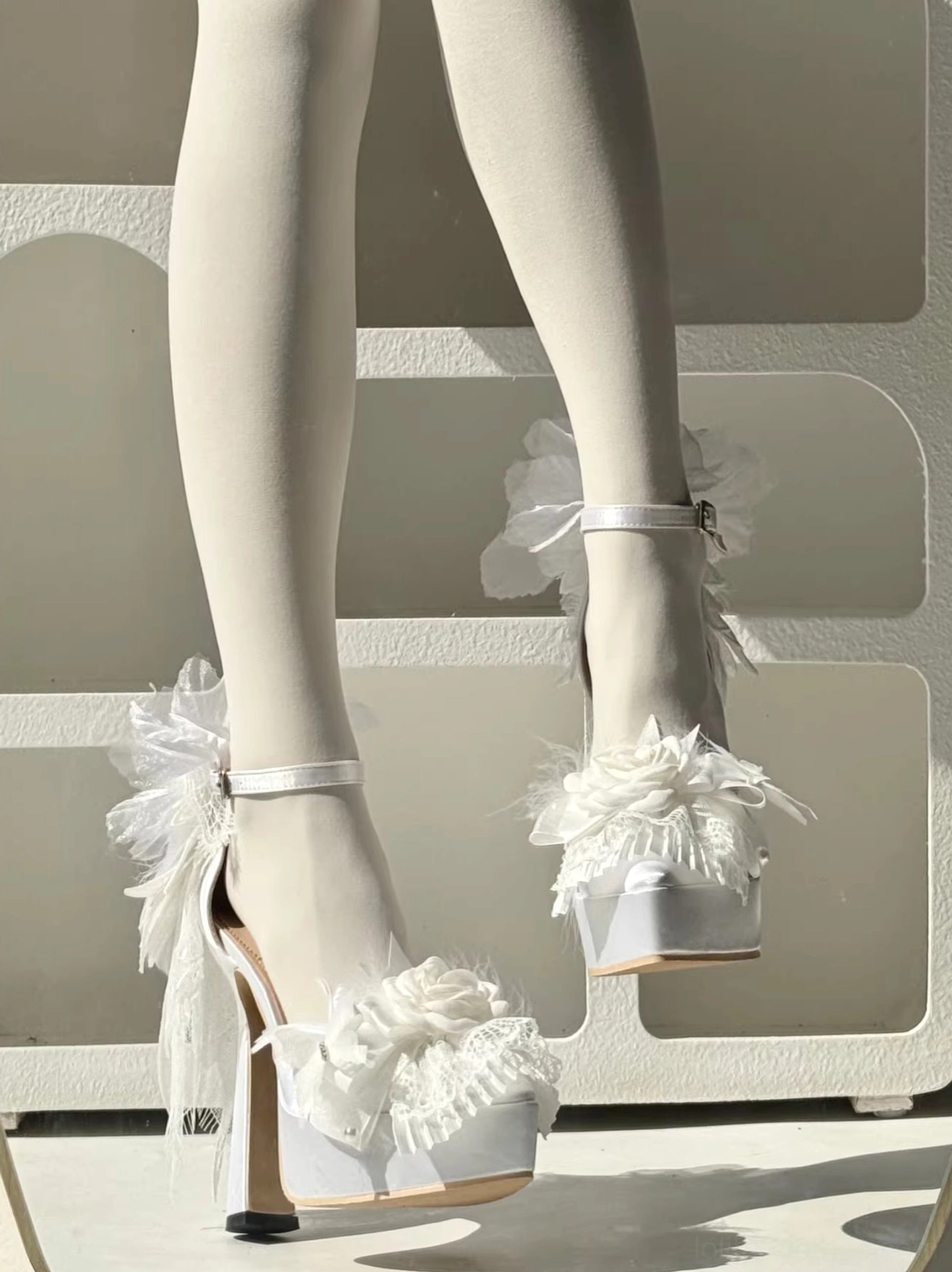 Feather spirit lolita platform heel shoes in black gothic style, featuring oversized feather heel decoration, satin material luxury finish, and ankle buckle closure mechanism