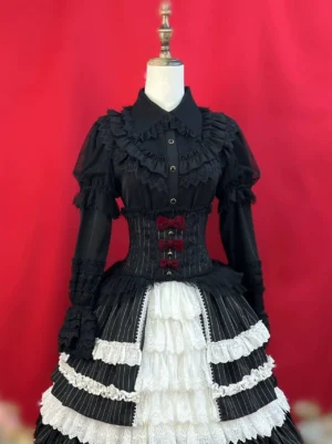 Black gothic lolita blouse with matching corset skirt set featuring puffed ruffled long sleeves front button closure striped corset waist bow accents and layered ruffled lace hem on dress form red studio background