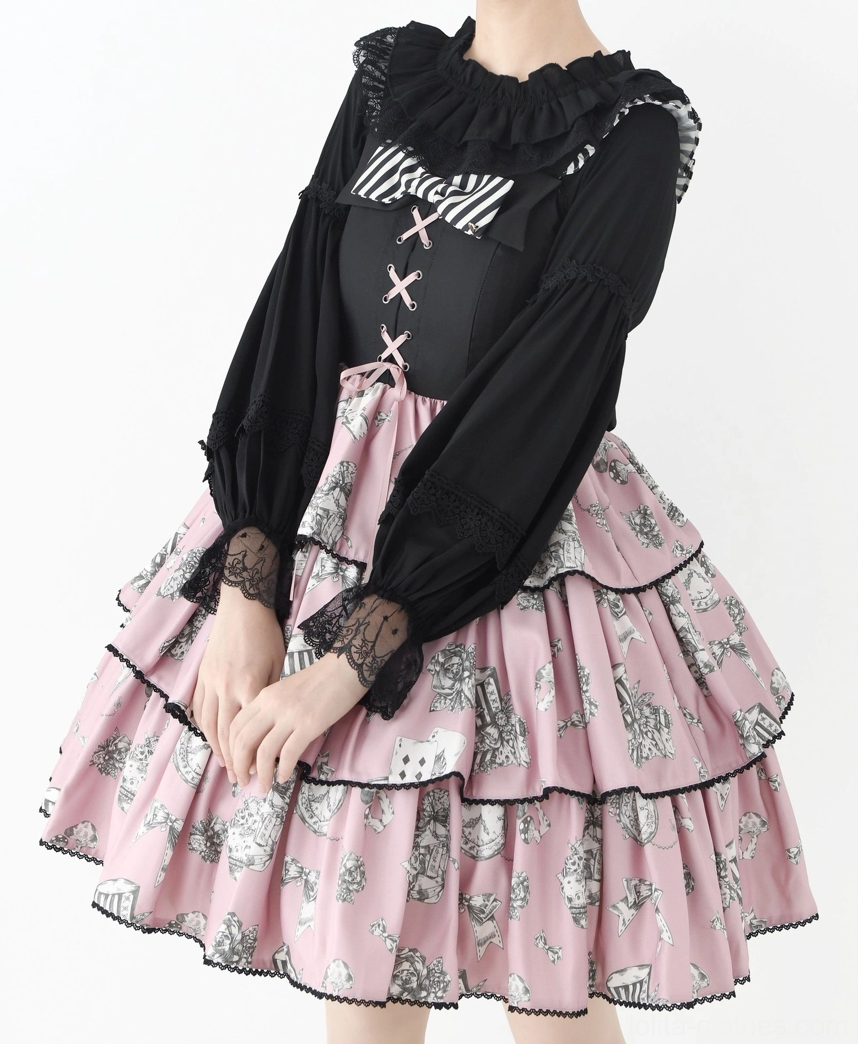 Black gothic-style Lolita blouse with crisscross strap details and contrast ruffled neckline styled with pink tiered printed Lolita skirt