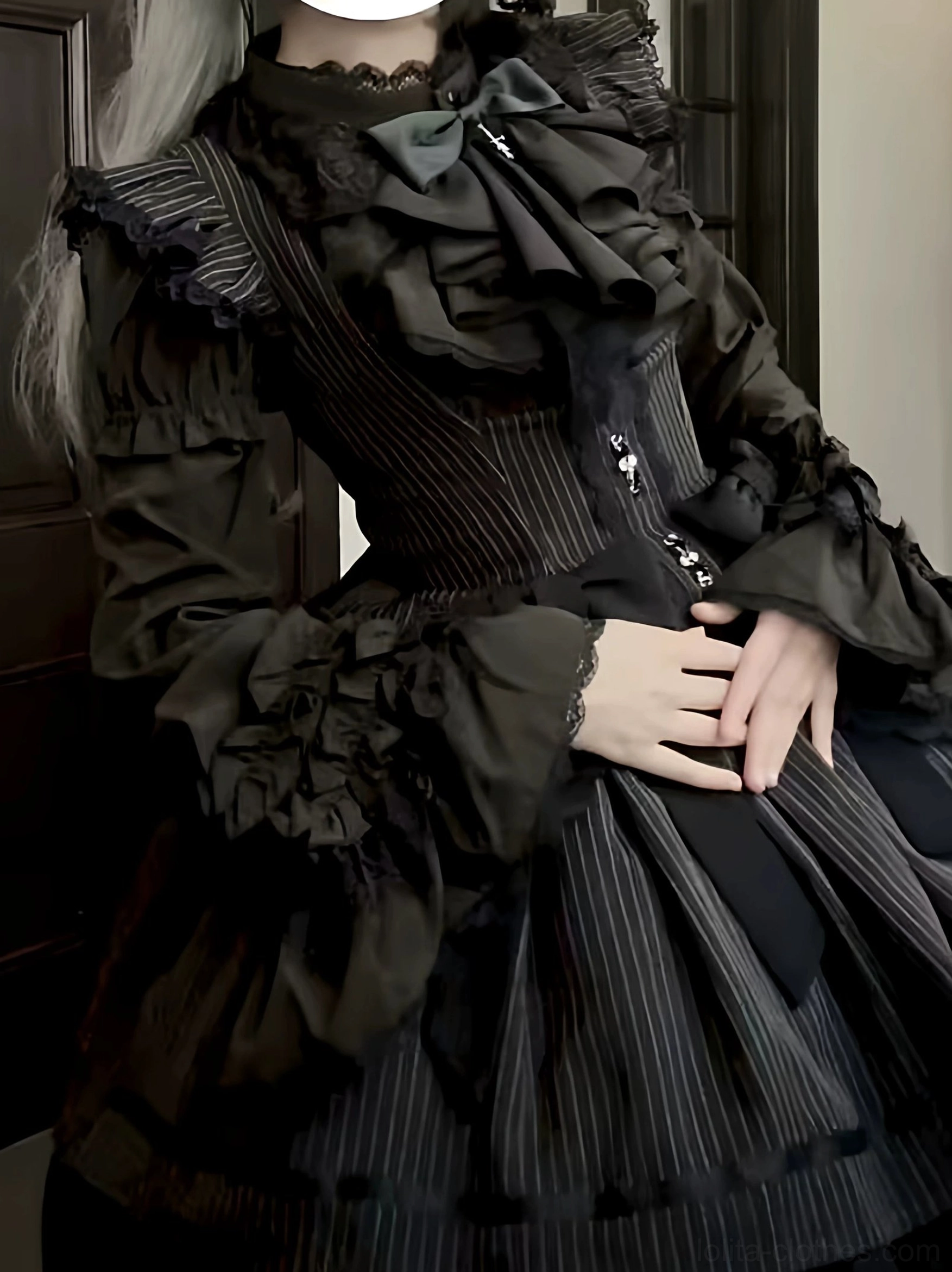 Black gothic lolita blouse with pinstripe corset detail worn with detachable flared cuffs and bow neckline