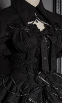 Black gothic lolita corset bolero dress cropped jacket with buttoned front lace-up details chain accents multi-layered ruffled lace hem close-up detail shot