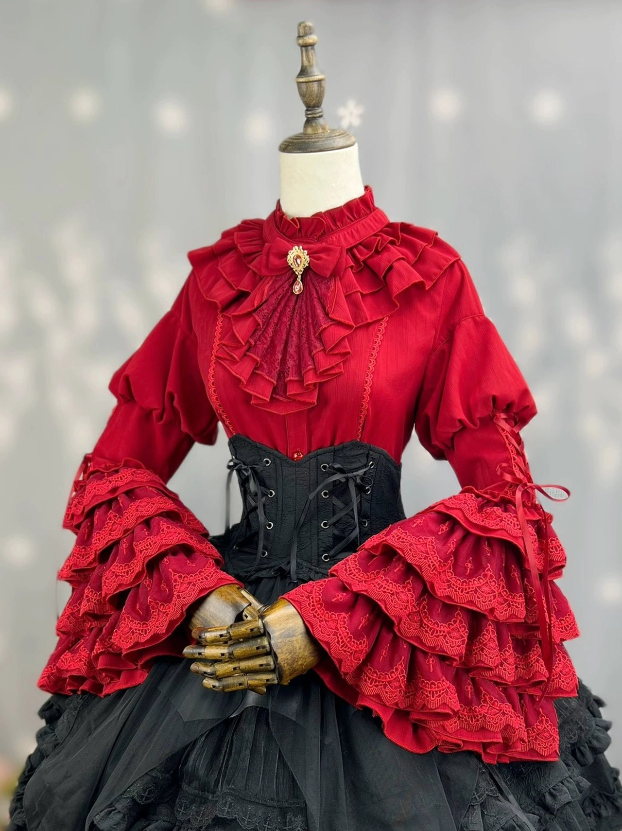 Black gothic lolita dress back detail showing lace-up corset construction ruffled collar princess sleeve back view and layered ruffle skirt design