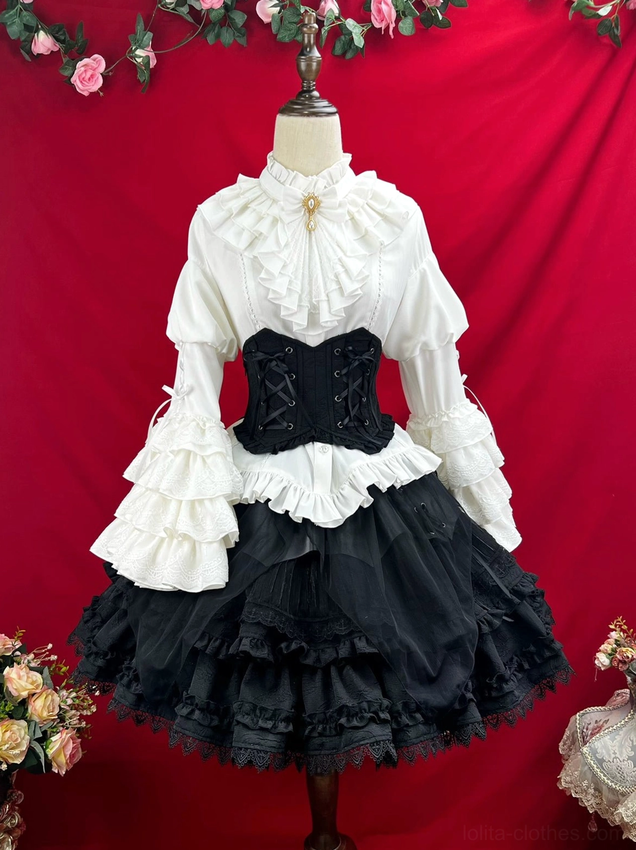 Black gothic lolita corset dress detail showing high neck ruffled collar fitted waist princess sleeve bell construction and layered short skirt