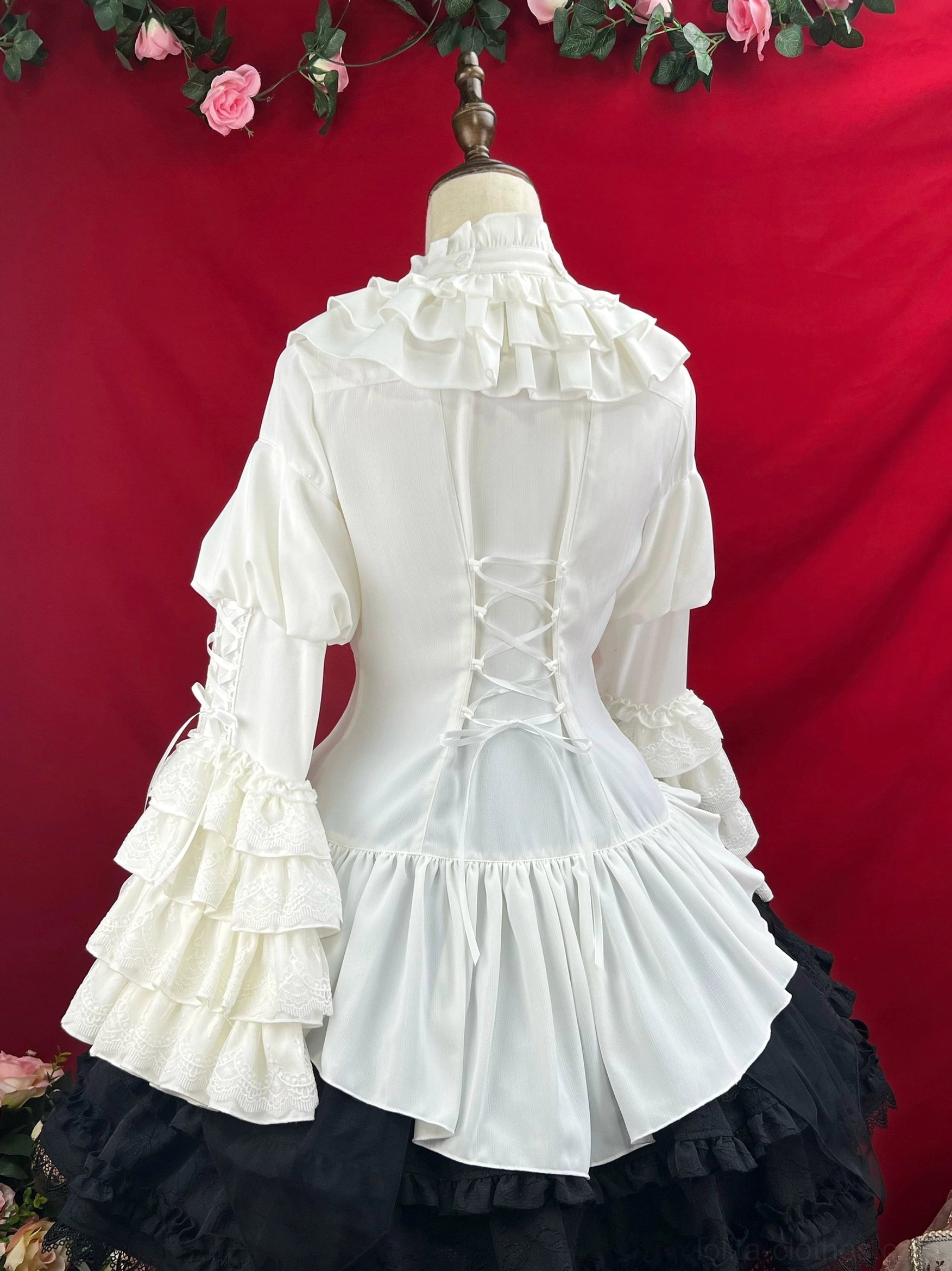Black gothic lolita dress full-length display showing princess sleeves with bell construction layered ruffled skirt corset waist and high neck ruffled collar