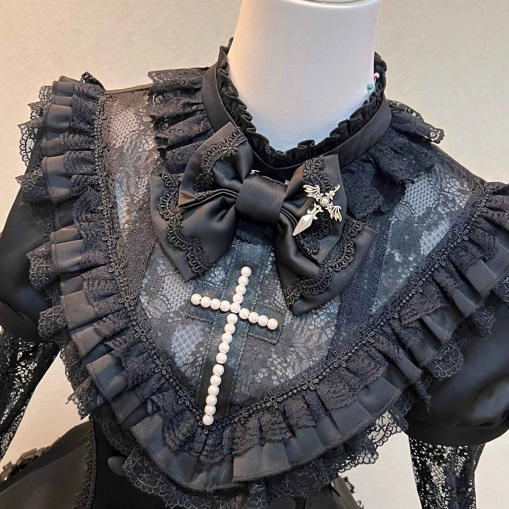 Black Gothic Lolita OP dress with optional long lace sleeves attachment showing convertible sleeve styling dramatic full coverage option