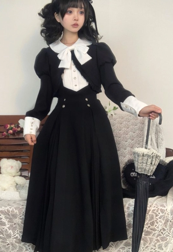 Black Gothic Lolita one-piece dress worn with coordinating matching black coat, model styled with traditional Lolita accessories demonstrating complete outfit coordination