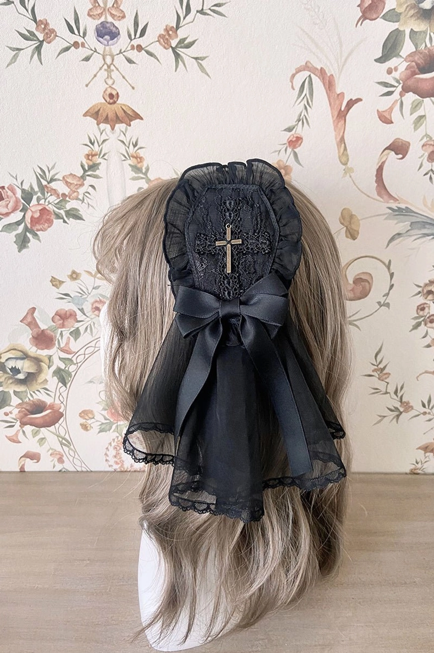 Black Gothic Lolita hair clip with gold cross ornament and sheer black veil on brown mannequin hair
