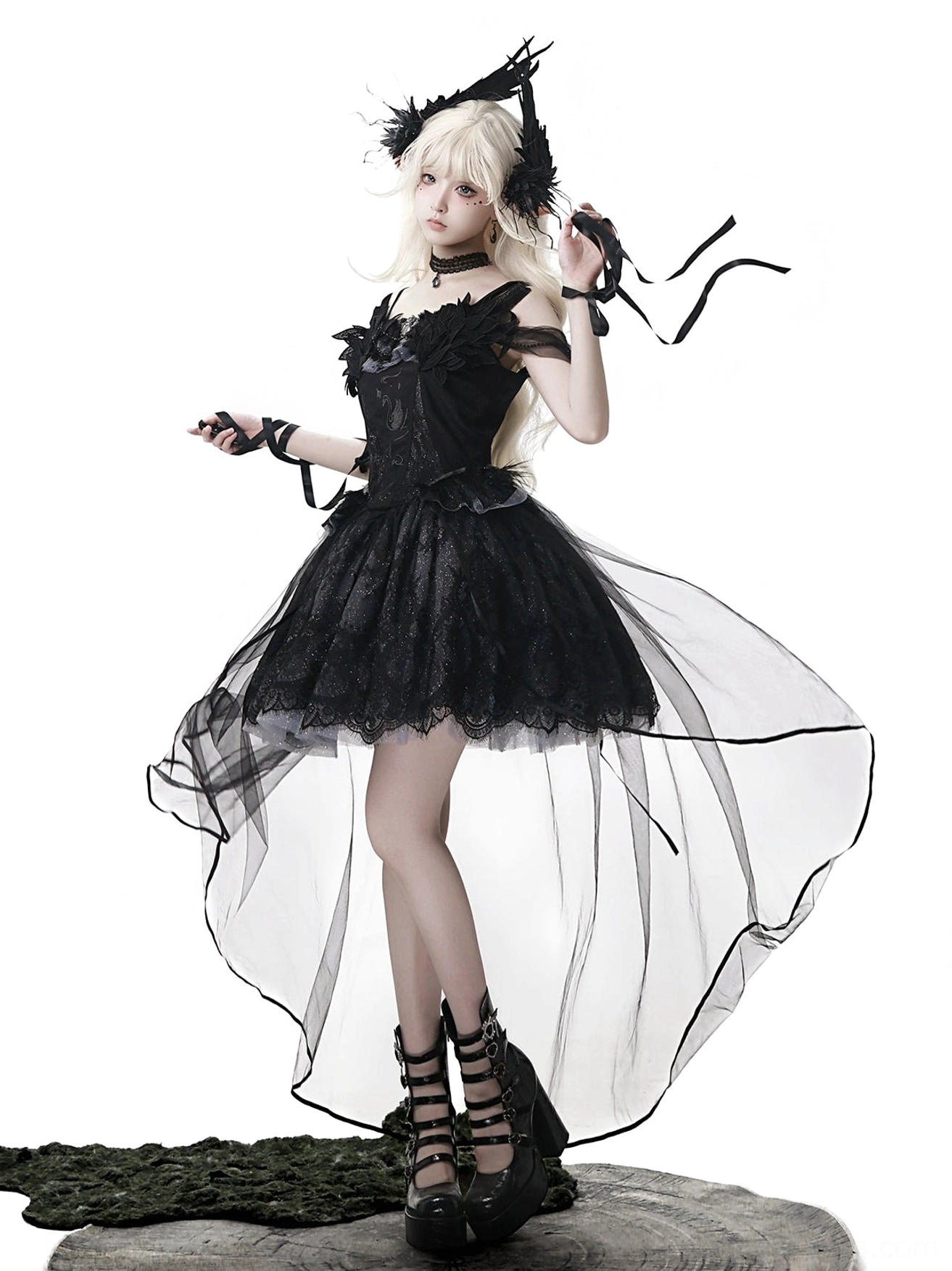 Black gothic lolita JSK full front angled view on model styled with black feather gothic headpiece, matching wrist cuffs and choker, lace bodice with high-low sheer tulle trim