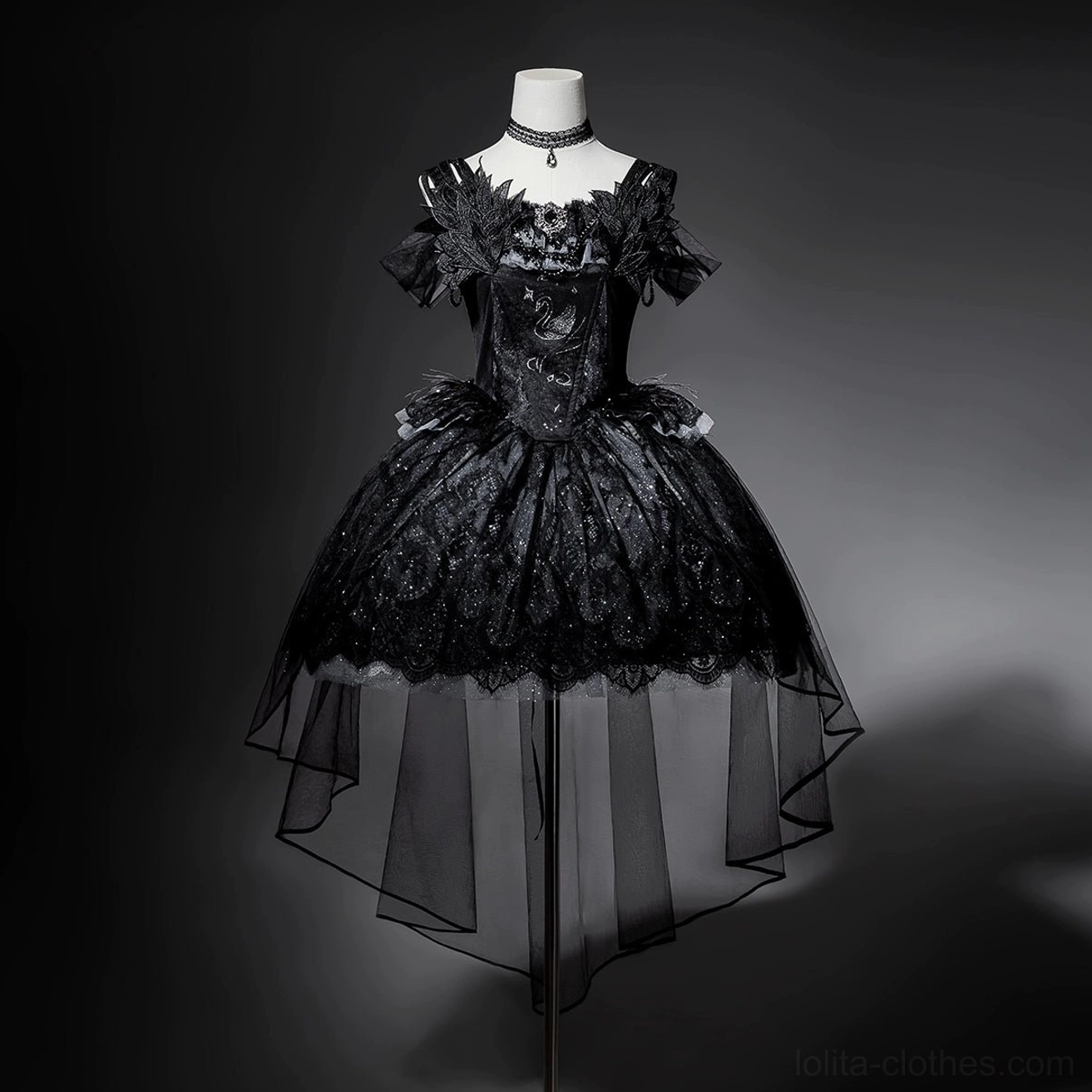 Black gothic lolita JSK dress on mannequin displaying front structure, corset-style bodice with ruffled lace neckline, glittery voluminous skirt with high-low tulle overlay