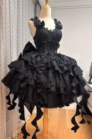 Black Gothic Lolita JSK Dress front view on mannequin showing corset bodice ruffled straps and multi-layered fluffy skirt with embroidered lace