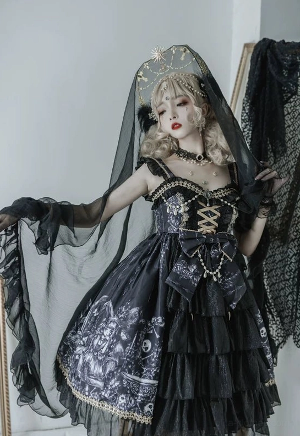 Black Gothic Lolita JSK Dress front full view with black veil headdress, crisscross lace-up front, waist bow decoration, and layered ruffled skirt