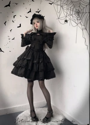Black gothic lolita JSK dress full-body front view with off-shoulder ruffled neckline and multi-tiered cake skirt silhouette