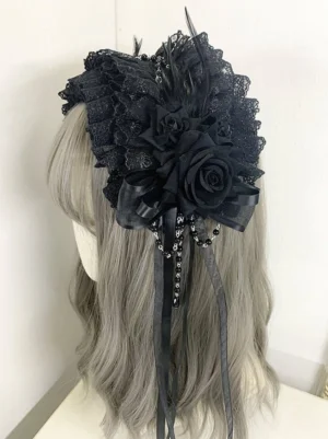 Black gothic lolita lace headdress with black silk roses ruffled lace feather trims and beaded satin ribbon tassels rear three-quarter view on mannequin