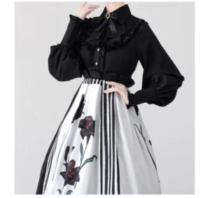 Black Gothic Lolita mutton sleeve blouse with ruffled stand collar and pointed hemline paired with lily print half skirt front view