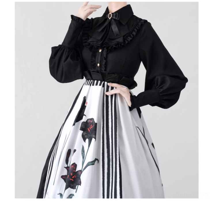 Black Gothic Lolita mutton sleeve blouse with ruffled stand collar and pointed hemline paired with lily print half skirt front view