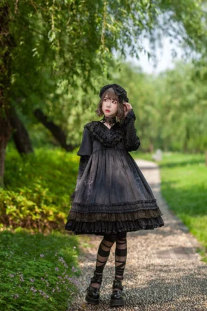 Black gothic lolita OP dress featuring cross embroidery and multi-layer lace skirt, full-body outdoor modeled with coordinating accessories