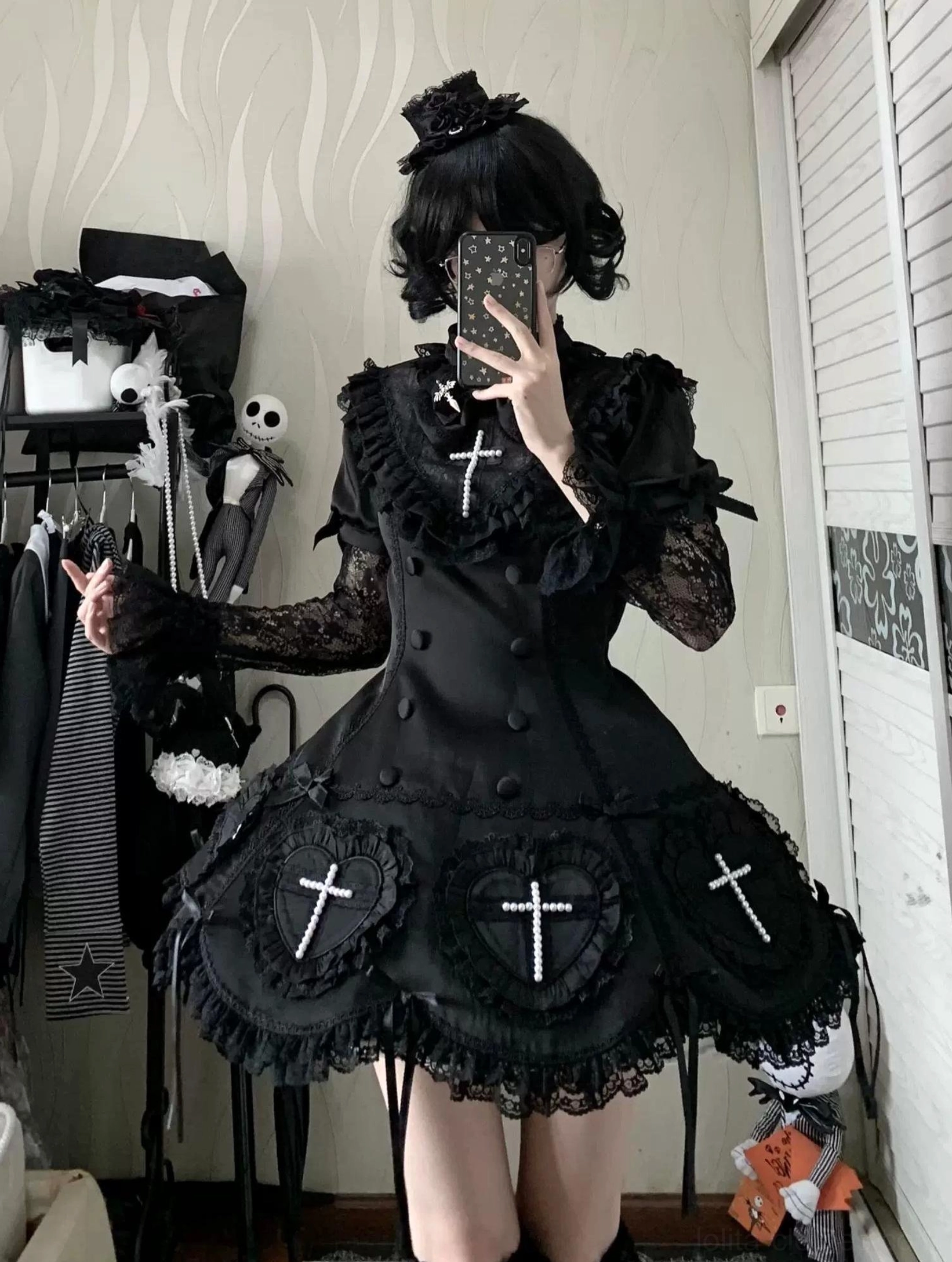 Black Gothic Lolita OP dress mirror selfie close-up showing sheer lace long sleeves cross motifs mini ruffled skirt matching hair hat accessory