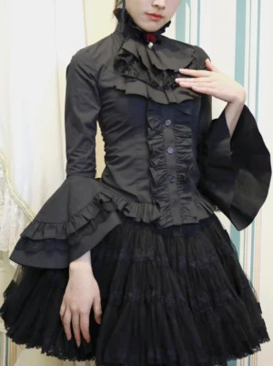 Black gothic lolita long-sleeve ruffled blouse with high stand collar and detachable jabot, front three-quarter view on female model wearing black tulle skirt