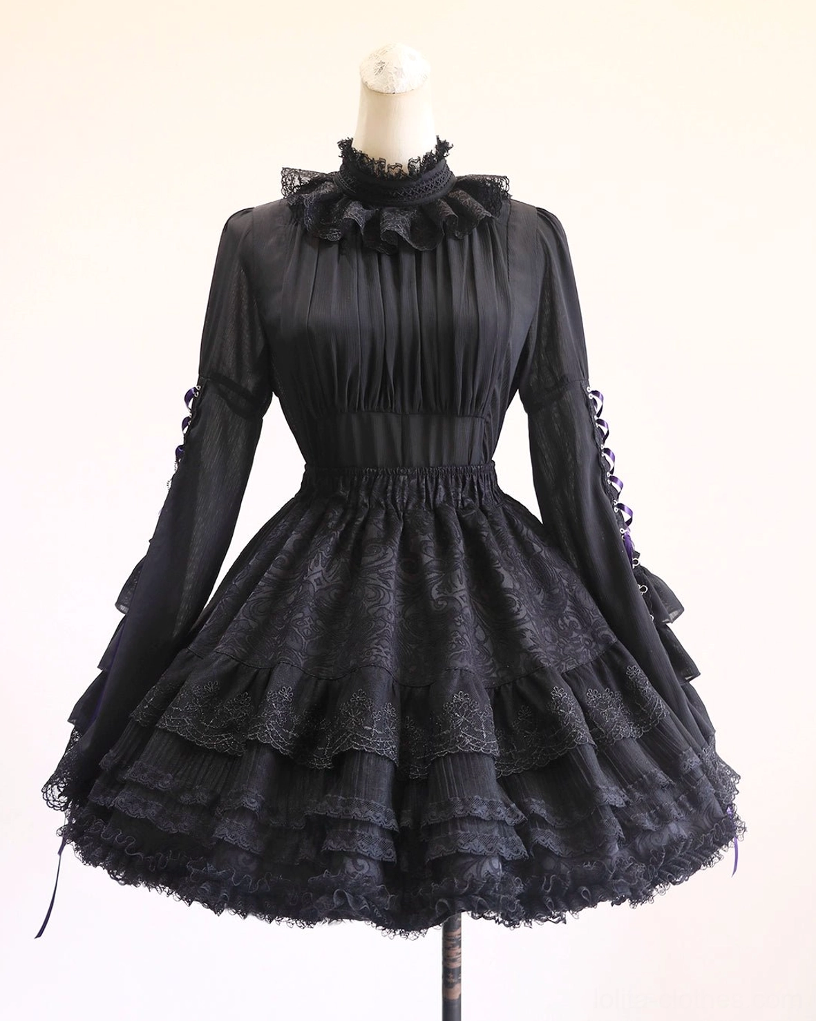 Black gothic lolita short skirt variant showing 42cm length proportion, compact ruffled hem with layered lace, elastic waist drawstring design, and refined casual-formal balance