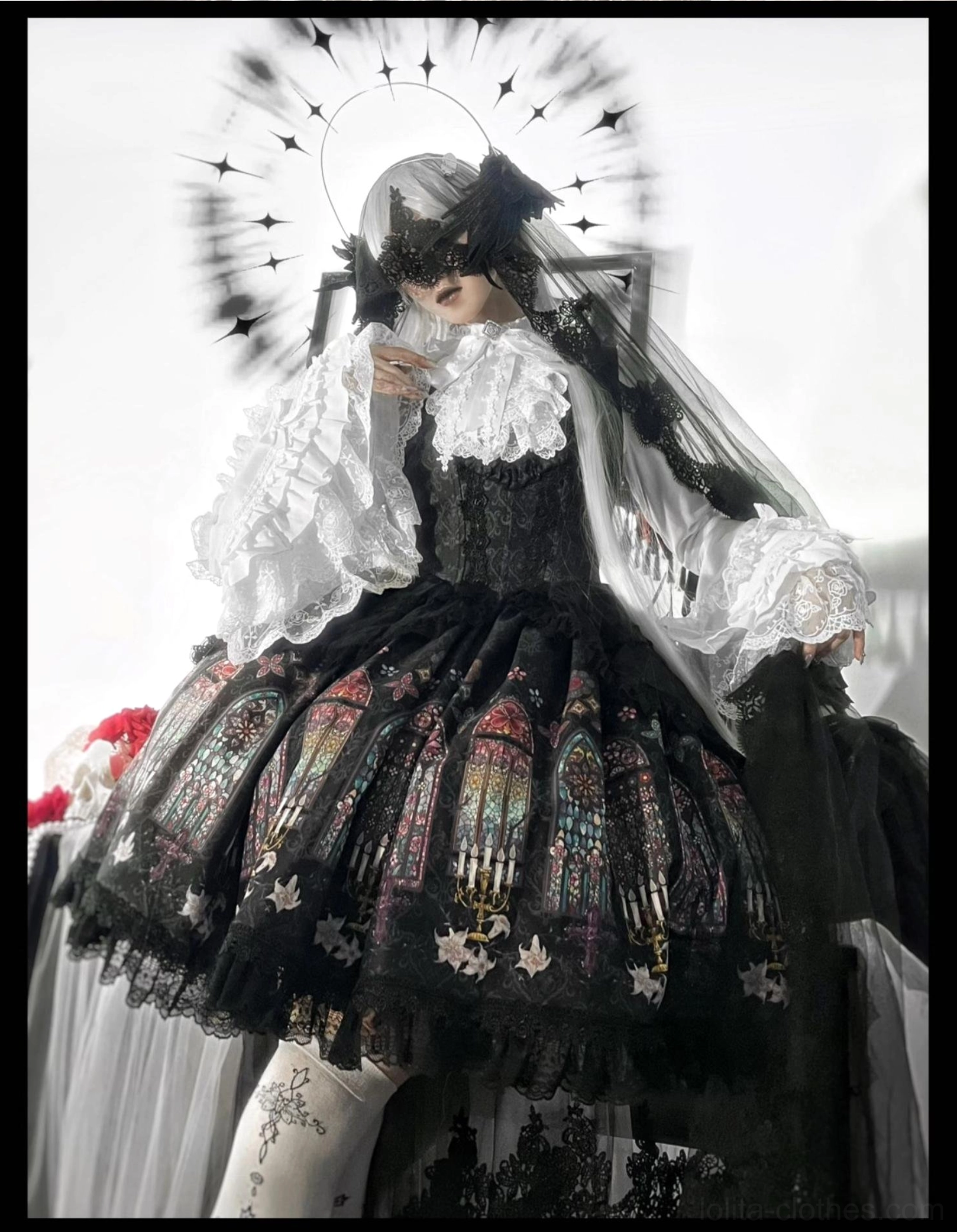 Model wearing black gothic lolita stained glass print full set with ruffled blouse veil headpiece and halo prop studio