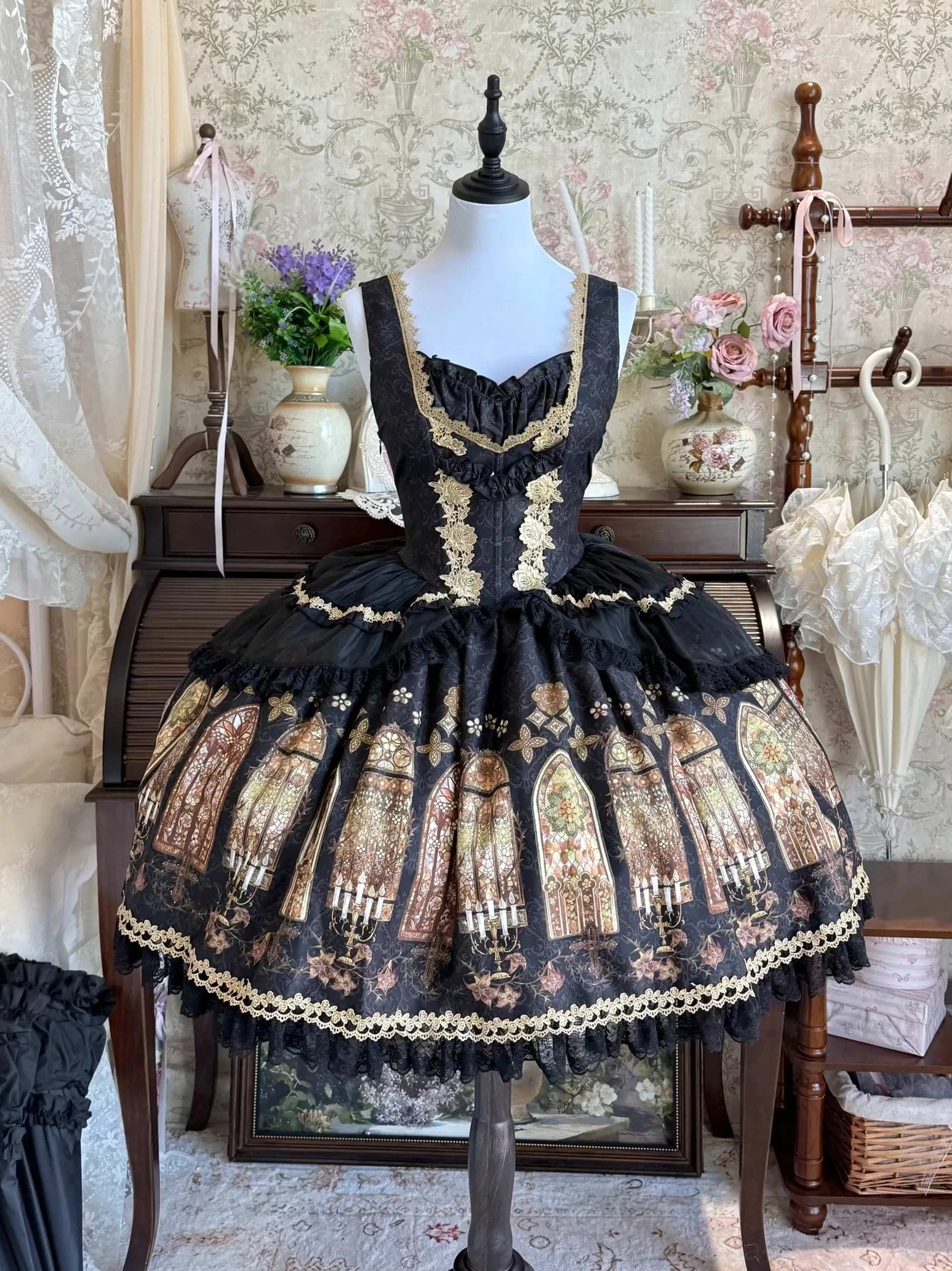 Black gothic lolita stained glass print JSK dress with gold neckline trim and layered black gold lace hem detail