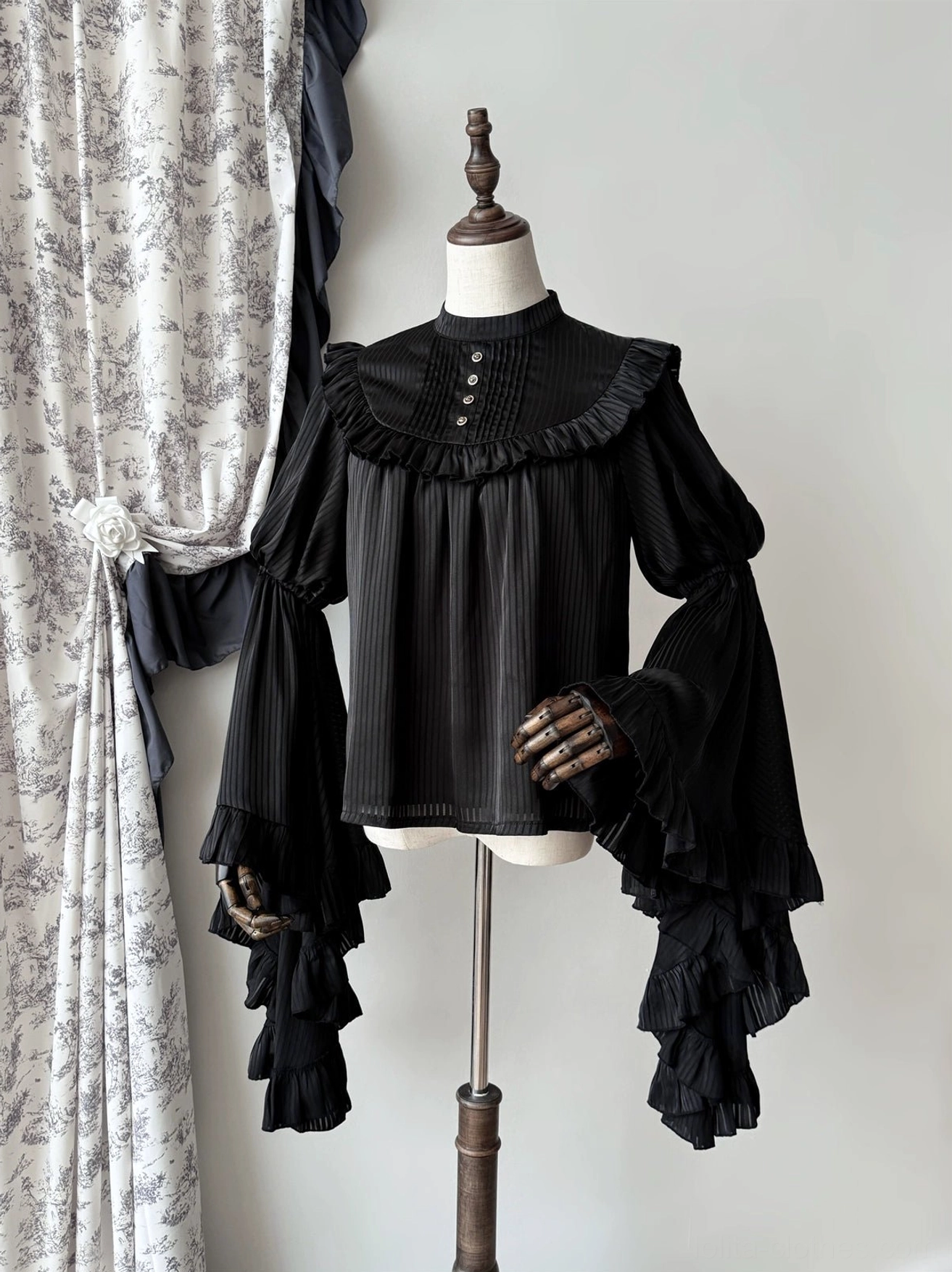 Black gothic lolita princess sleeve blouse with vertical striped pattern and ruffled yoke detail, front full view on dress form