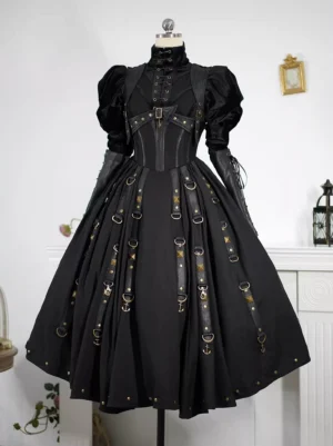 Front display shot of black gothic pirate lolita JSK jumper skirt dress with metal buckle harness details and puff mutton sleeves on dress form against white wall background