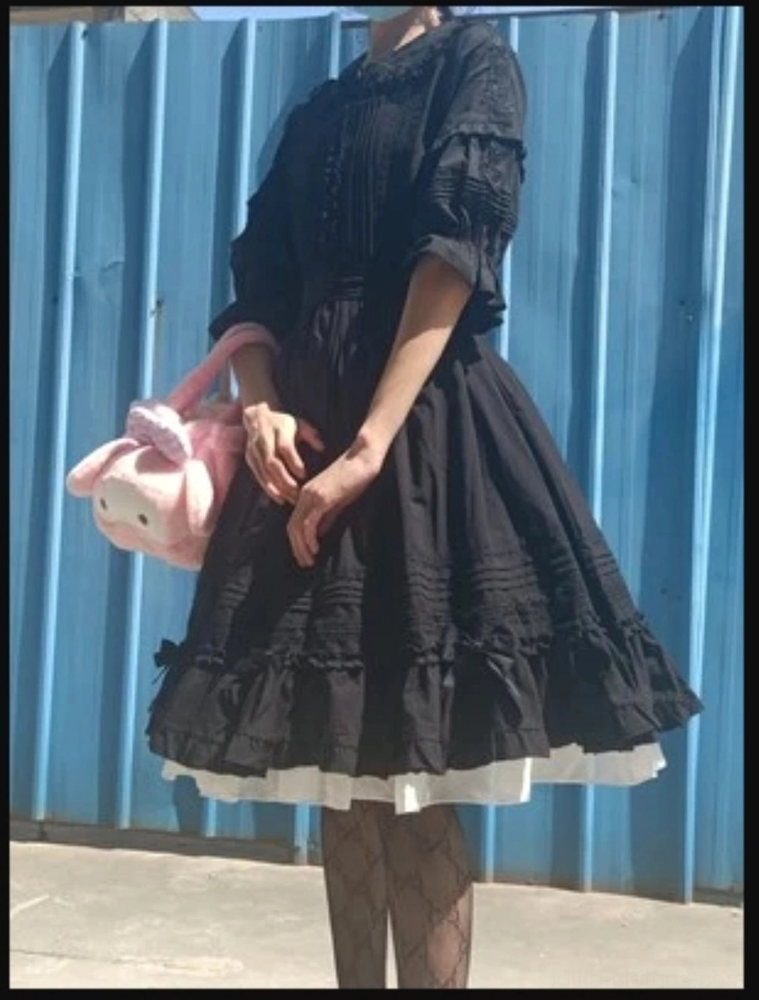 Black half-sleeve Peter Pan collar Lolita blouse with ruffled lace trim displayed flat showcasing elegant gothic-sweet aesthetic