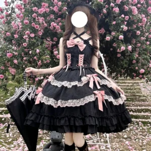 Black halter neck Sweet Lolita JSK dress with tiered ruffled skirt and white lace trims worn in outdoor rose garden setting