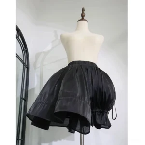 Black high-volume lolita bloomer petticoat with glossy fabric and ruffled hem on dress form, front view studio shot