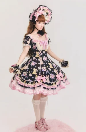 Full-body front view of black sweet lolita OP dress with teddy bear and floral prints, featuring pink ruffled lace trims, matching bonnet and gloves, displayed on pink fluffy studio rug