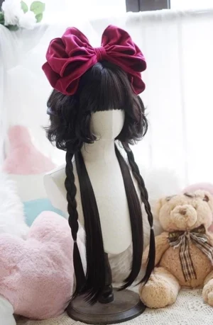 Black jellyfish curly lolita wig with long braids and burgundy velvet bow, front full view on mannequin with plush background