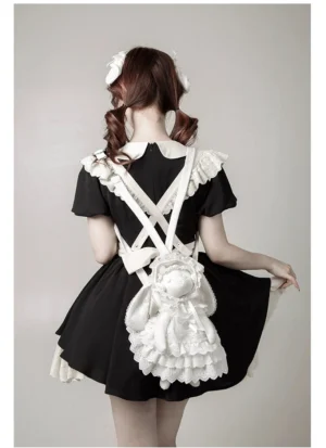 Black kitten Nana plush Lolita shoulder bag paired with black maid-style sweet Lolita dress featuring white ruffled collar and shoulder trims, back full-body view of model with twin curly buns