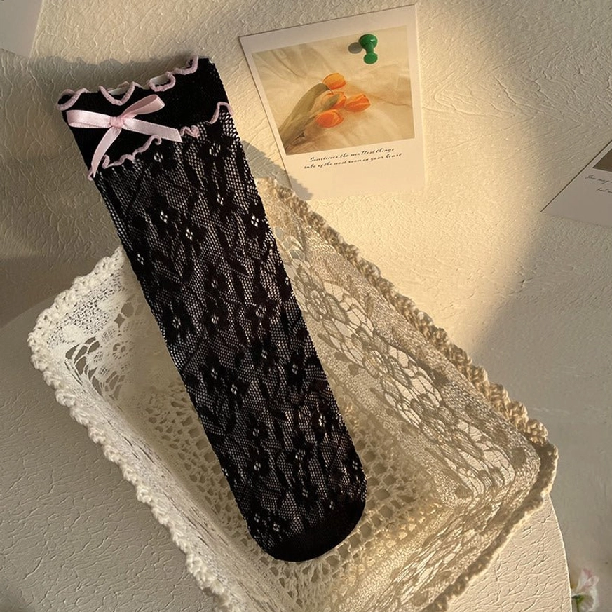 Black sheer lace Lolita ankle socks with pink ribbon bow featuring delicate floral pattern and reinforced ruffled cuff trim detail
