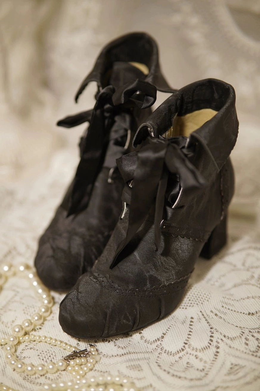 Black lolita ankle boots with faux pigskin leather lining visible from internal view showing premium material quality and comfort-focused construction