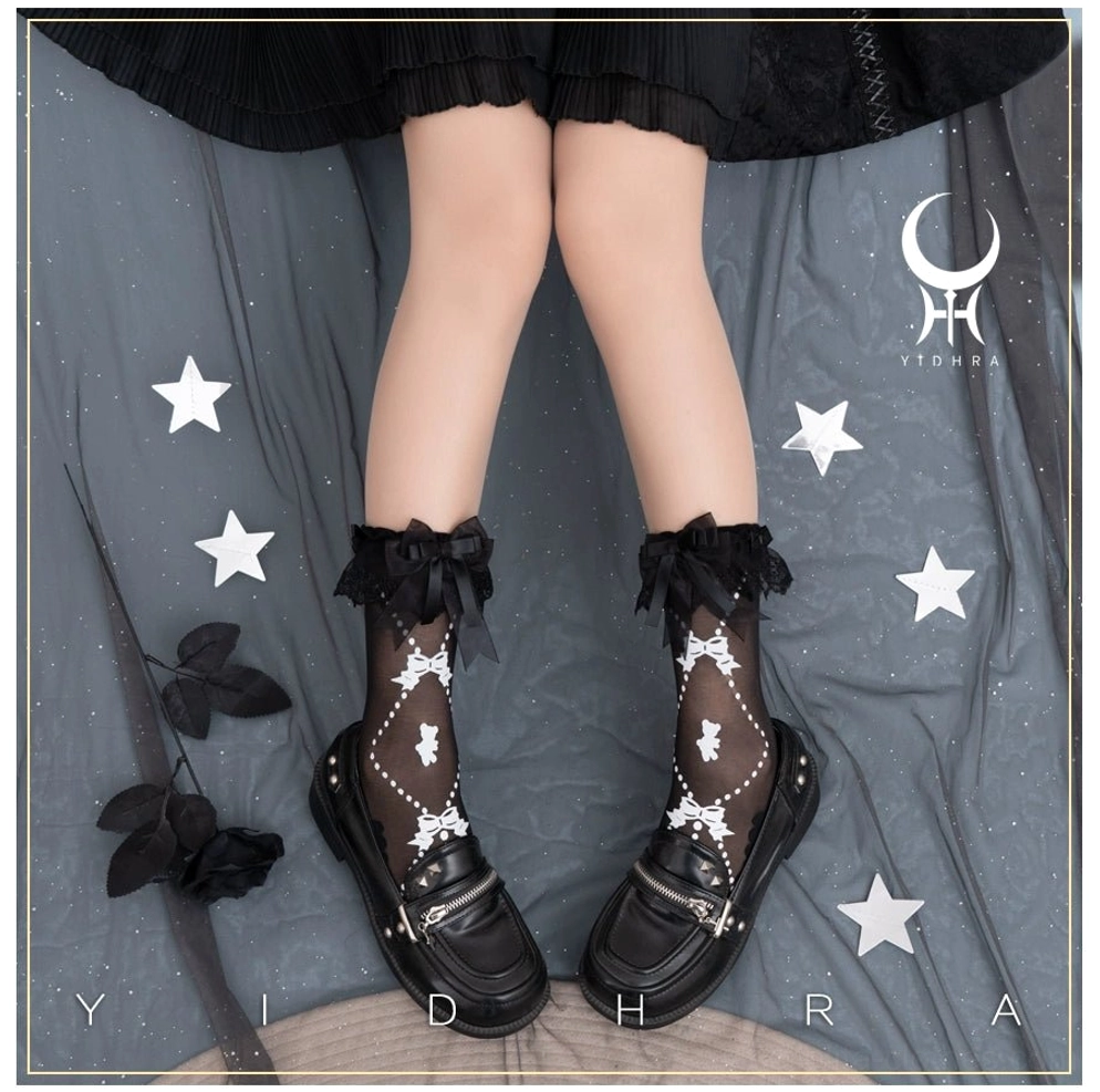 Black lolita ankle socks paired with black leather loafers and black lace ruffle bow cuff showing white bear and bow printed details on sheer black fabric