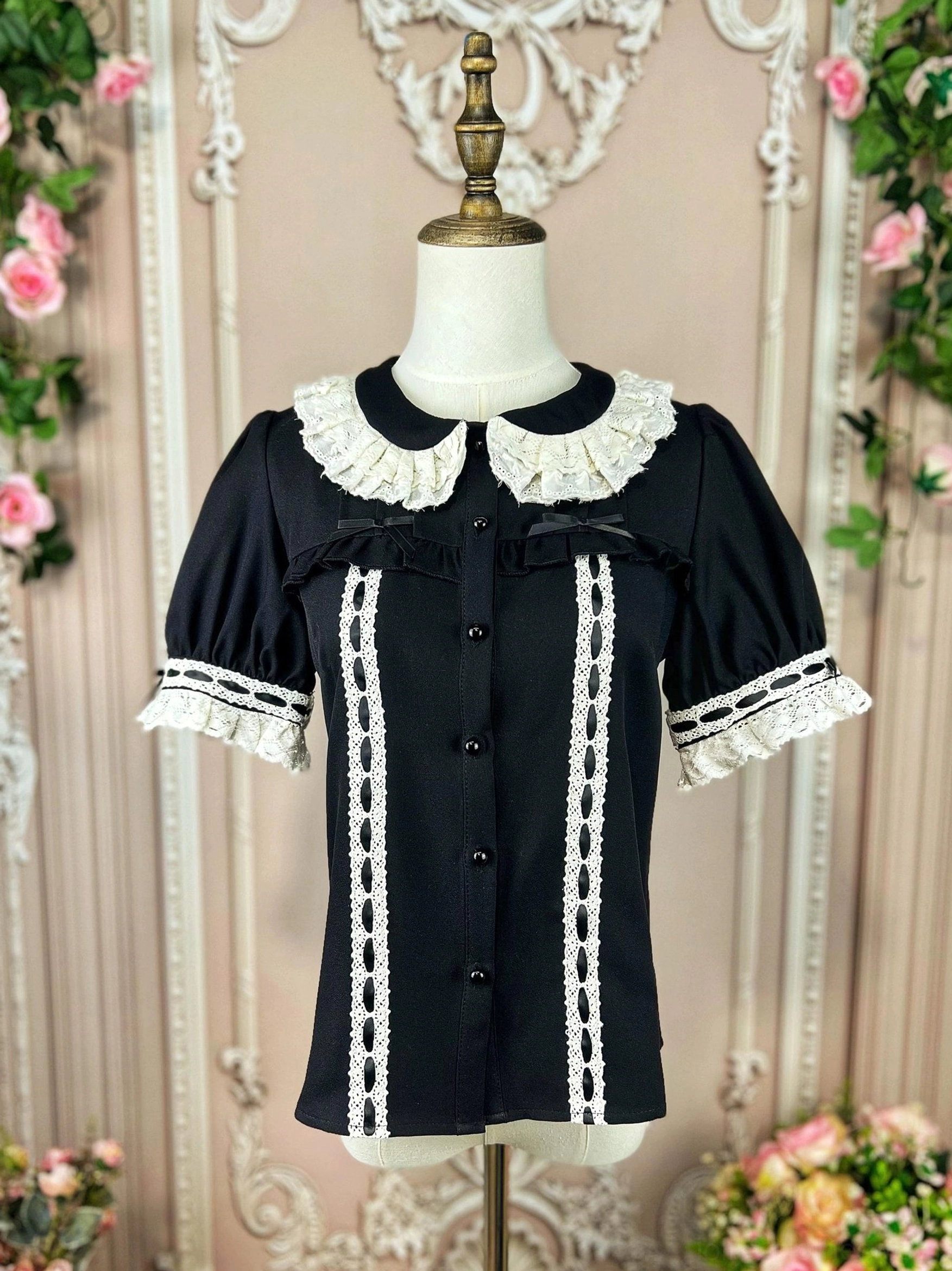 Black lolita blouse close-up detail shot showing premium pearl-style buttons front placket lace ribbon trim and precision-cut lace edges on collar and sleeves